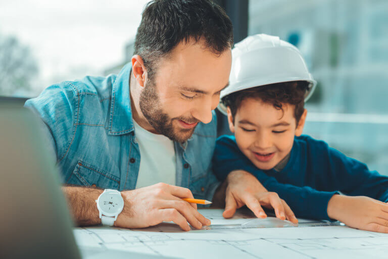 Ein Vater in Teilzeitausbildung mit seinem Sohn.