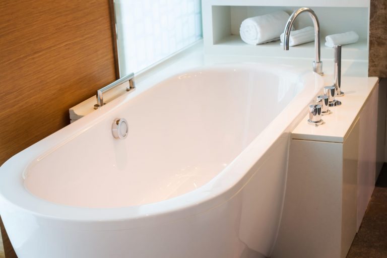 Bathroom interior in cozy colors with modern bathtub