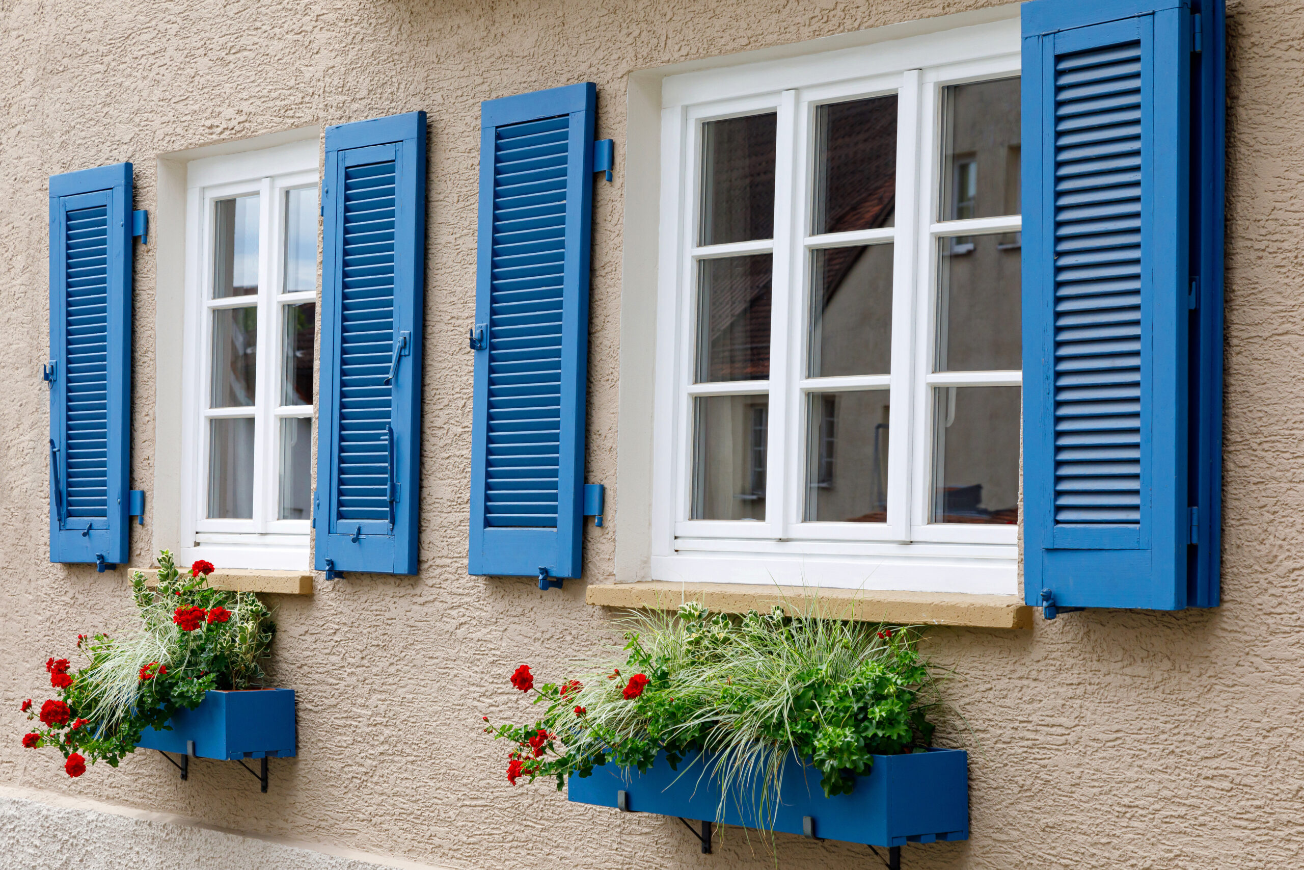 Kastenfenster mit blauen Fensterläden.