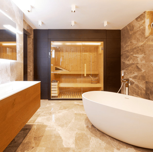 Ein Badezimmer mit Sauna, Badewanne und Waschbecken. Ausgestattet mit Großformatfliesen.